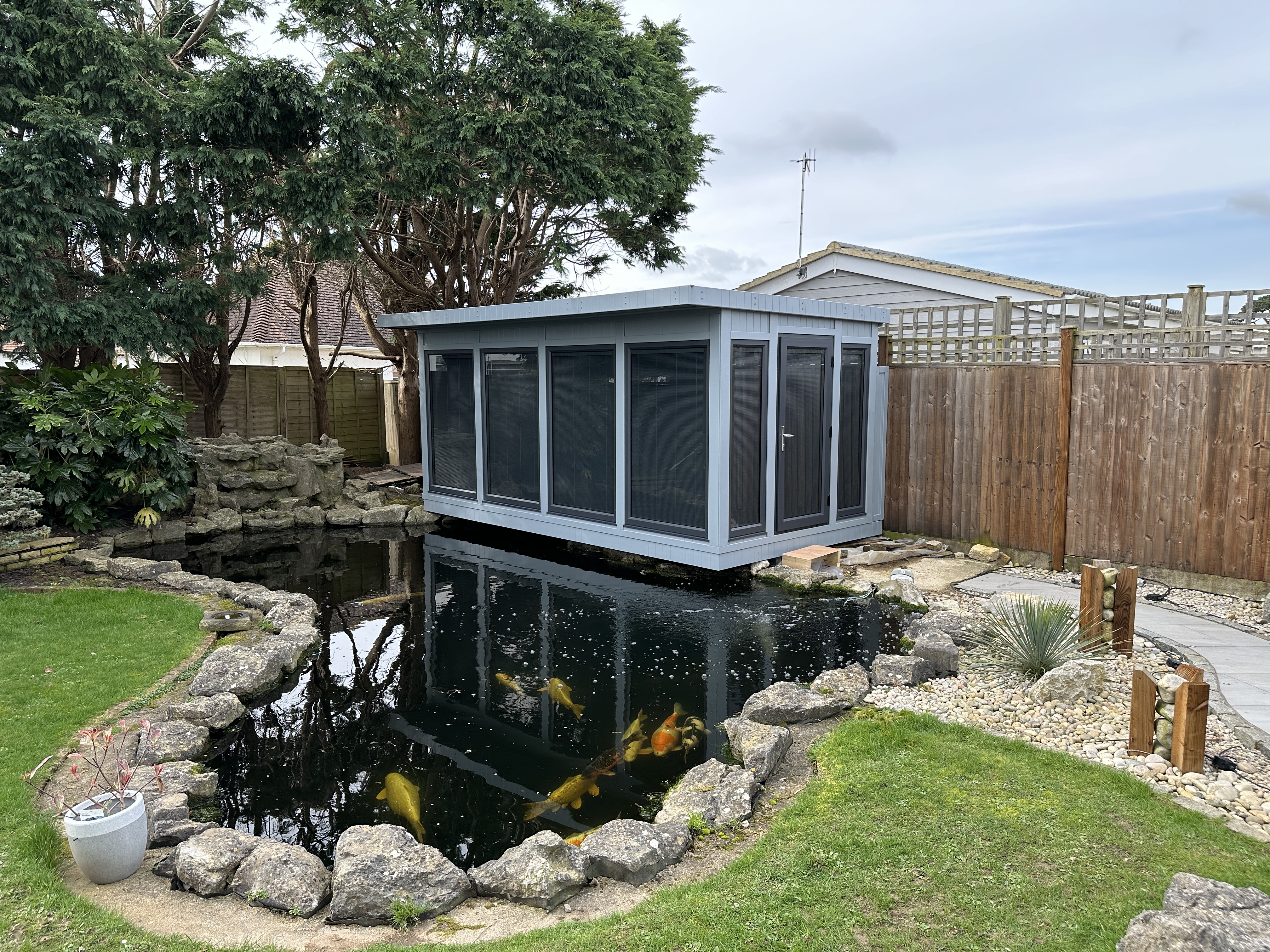 Cantilevered garden room over pond 